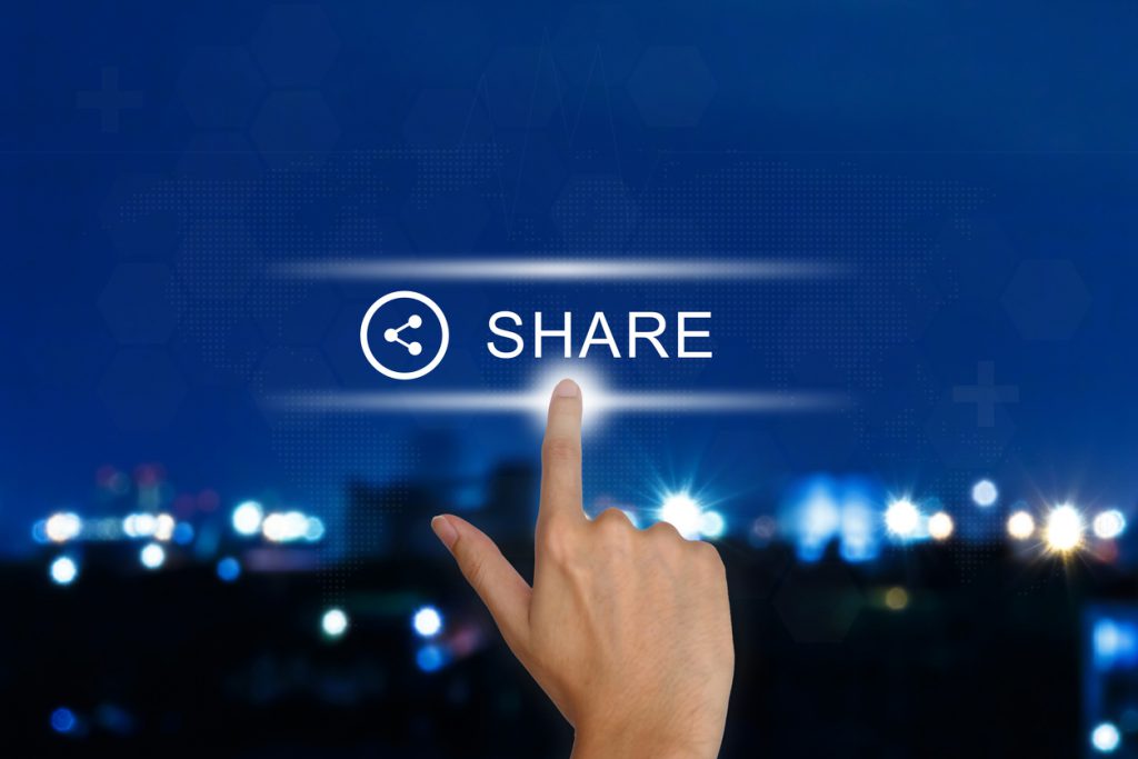 hand pushing share button on touch screen