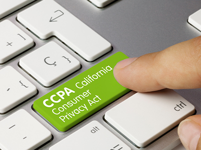 Green CCPA compliance button on computer keyboard.